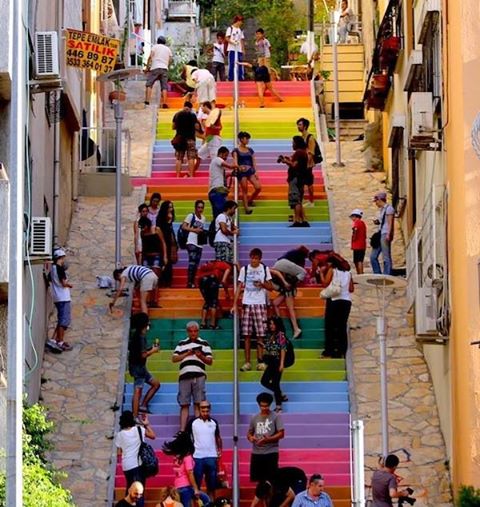 A 64 year-old man in Istanbul decided to brighten the neighborhood by painting rainbow colors on some wide, gray, crumbling stairs. When municipal officials sent workers after nightfall to hurriedly repaint the steps gray, a quiet revolution started on Twitter. Not only did volunteers come out to repaint those stairs that Huseyin Cetinel had spent hundreds of dollars on, they painted other stairs and walkways in cities around Turkey, posting photos on social media. A Pandora's Box of color had unwittingly been opened.